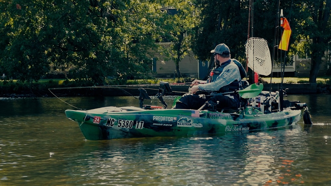 Man in kayak fishing on a river