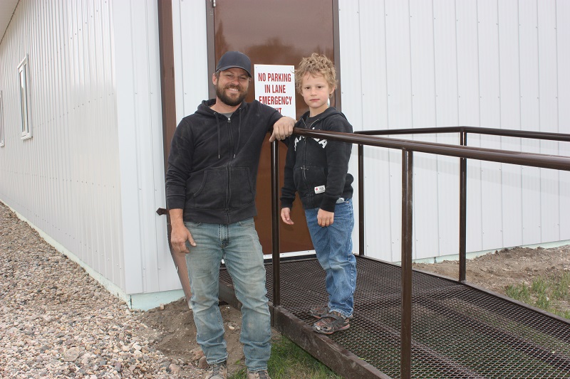 Father and son standing on an access ramp