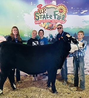 Teenage 4-H winner with a steer