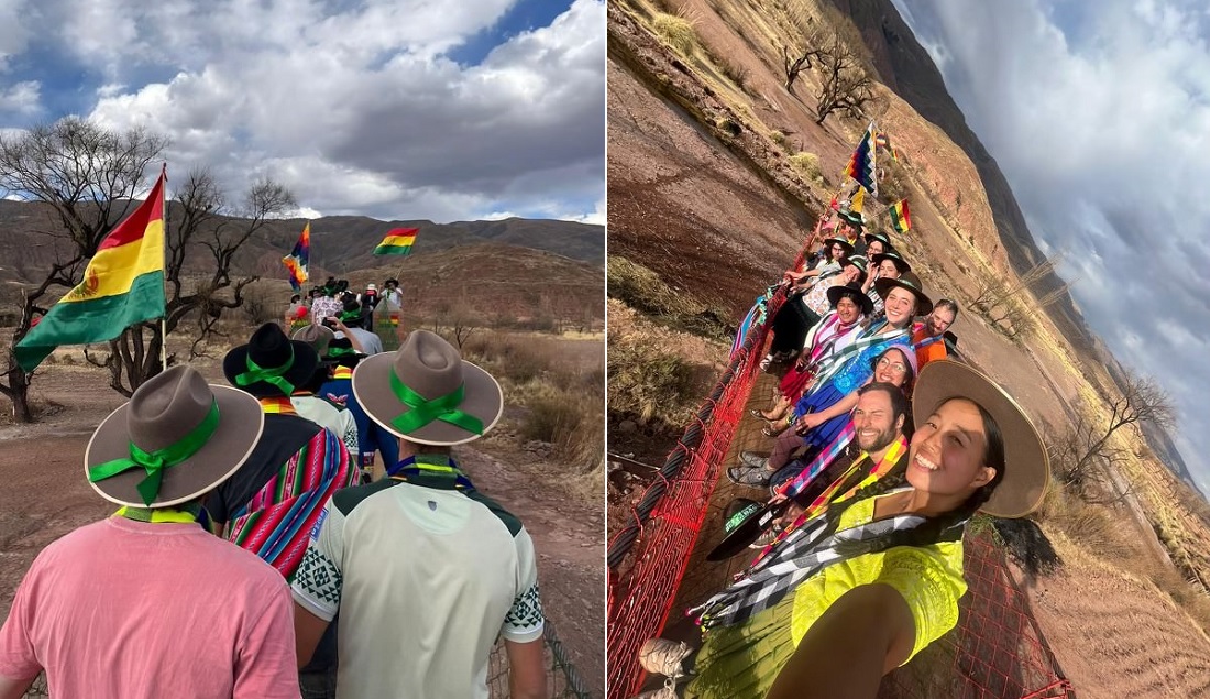 People in brightly colored costumes on a footbridge